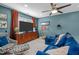 Lounge features blue walls, blue sofa, orange curtains and large screen TV at 1004 Manderston Ln, Apex, NC 27502