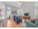 Bright living room with vaulted ceilings, large windows, a fireplace, and comfortable seating arrangement at 1004 Manderston Ln, Apex, NC 27502