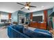 Lounge features blue walls, blue sofa, orange curtains and large screen TV at 1004 Manderston Ln, Apex, NC 27502