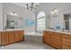 Luxurious bathroom featuring a large soaking tub, double vanities, and decorative lighting at 1004 Manderston Ln, Apex, NC 27502