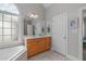 Well-lit primary bathroom with bathtub, single vanity, and tile flooring at 1004 Manderston Ln, Apex, NC 27502