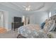 Bright bedroom featuring a king bed, flat screen television, and plenty of natural light at 1004 Manderston Ln, Apex, NC 27502