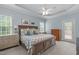 Inviting bedroom with beautiful decor, large bed, ceiling fan, and natural light at 1004 Manderston Ln, Apex, NC 27502