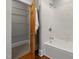 Bathroom with tub, tile surround, and linen closet in the hall at 1008 Dorothea Dr, Raleigh, NC 27603