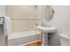 Standard tiled bathroom with a white pedestal sink and tub/shower combo at 1008 Dorothea Dr, Raleigh, NC 27603