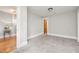 A spacious bedroom with carpeted floors, neutral walls, and ample natural light from a large door at 1008 Dorothea Dr, Raleigh, NC 27603