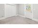 Neutral bedroom with carpet, large closet, and door with view of backyard at 1008 Dorothea Dr, Raleigh, NC 27603