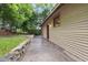 Back view of building and backyard featuring stone patio and landscaping at 1008 Dorothea Dr, Raleigh, NC 27603
