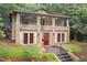 Beautiful two-story home with a cozy porch and a well-maintained yard, enhanced by a vibrant red door at 1008 Dorothea Dr, Raleigh, NC 27603
