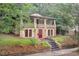 Charming two-story home featuring a front porch with manicured landscaping and a red front door at 1008 Dorothea Dr, Raleigh, NC 27603