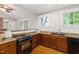 Kitchen featuring granite countertops, stainless steel appliances, and hardwood flooring at 1008 Dorothea Dr, Raleigh, NC 27603