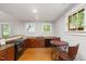 Modern kitchen with granite countertops, dark wood cabinets, and a cozy dining area at 1008 Dorothea Dr, Raleigh, NC 27603