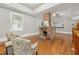 Sunlit living area showcases beautiful hardwood flooring, brick fireplace, and comfortable seating at 1008 Dorothea Dr, Raleigh, NC 27603