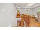 A staircase leads up into a well-lit room with wood floors and brick fireplace at 1008 Dorothea Dr, Raleigh, NC 27603