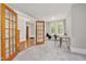 An inviting living room with a fireplace, plush carpet, and natural light from a large window at 1008 Dorothea Dr, Raleigh, NC 27603