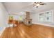 Bright and airy living space featuring hardwood floors, a brick fireplace, and staircase at 1008 Dorothea Dr, Raleigh, NC 27603