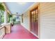 Charming porch features red painted floor and classic columns and doorway at 1008 Dorothea Dr, Raleigh, NC 27603