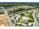 Aerial view of a well-planned community featuring a pool, tennis courts, clubhouse, and residential area at 102 Michelangelo Pl, Morrisville, NC 27560