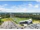 Topgolf complex featuring a driving range, parking lot, and entertainment building, all set against a wooded backdrop at 102 Michelangelo Pl, Morrisville, NC 27560