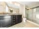 Bathroom with a double sink vanity, granite countertop, and glass-enclosed shower at 102 Michelangelo Pl, Morrisville, NC 27560
