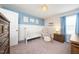 Bedroom with blue and white walls, carpet, a crib, a chair, and multiple windows at 102 Michelangelo Pl, Morrisville, NC 27560