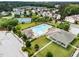 Aerial view of a community pool and clubhouse surrounded by lush landscaping and residential homes at 102 Michelangelo Pl, Morrisville, NC 27560