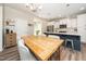 Dining area with a wooden table, pendant lighting, and an open view to the kitchen at 102 Michelangelo Pl, Morrisville, NC 27560