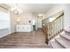 Spacious entryway featuring hardwood floors, stairs, and a decorative sideboard at 102 Michelangelo Pl, Morrisville, NC 27560