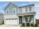 Inviting two-story home with a classic facade, front porch, and well-manicured landscaping at 102 Michelangelo Pl, Morrisville, NC 27560