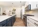 Well-equipped kitchen with stainless steel appliances, countertops, and a functional island with seating at 102 Michelangelo Pl, Morrisville, NC 27560