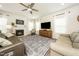 Bright and airy living room with a fireplace, neutral decor, and an elegant area rug at 102 Michelangelo Pl, Morrisville, NC 27560