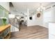 Open-concept living space showcasing stairs, hardwood floors, and stylish lighting fixtures at 102 Michelangelo Pl, Morrisville, NC 27560