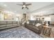 Open concept living room featuring a cozy couch, area rug, and a view of the kitchen and staircase at 102 Michelangelo Pl, Morrisville, NC 27560