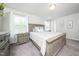 Bright main bedroom with a large bed, side tables, neutral walls, carpet and multiple windows at 102 Michelangelo Pl, Morrisville, NC 27560