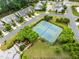 Aerial view of community tennis courts nestled in a green space with surrounding trees and neighborhood streets at 102 Michelangelo Pl, Morrisville, NC 27560