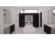 Clean bathroom design with free-standing tub, modern sinks, black accents, and bright lighting at 1021 Ferson, Apex, NC 27519