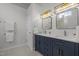 Modern bathroom with double sinks, navy cabinets, gold hardware, and excellent lighting at 103 Lake Tillery Dr, Cary, NC 27519
