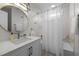 Bathroom with vanity, round mirror, and shower with a white curtain at 103 Lake Tillery Dr, Cary, NC 27519