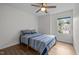 Bright bedroom with a ceiling fan, wood floors, and a window with a view at 103 Lake Tillery Dr, Cary, NC 27519