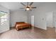Bright bedroom featuring hardwood floors, large windows, and a doorway to a walk-in closet at 103 Lake Tillery Dr, Cary, NC 27519