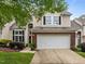 Attractive home featuring a two-car garage, brick accents, and manicured landscaping at 103 Lake Tillery Dr, Cary, NC 27519