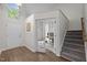 Open foyer with a staircase and double doors leading to an office at 103 Lake Tillery Dr, Cary, NC 27519