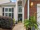Inviting home entrance with a tall entry door and red brick accents at 103 Lake Tillery Dr, Cary, NC 27519