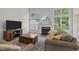 Cozy living room featuring a fireplace, large windows, and comfortable seating at 103 Lake Tillery Dr, Cary, NC 27519