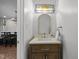 Stylish powder room with a modern vanity, elegant mirror, and designer lighting fixture at 103 Lake Tillery Dr, Cary, NC 27519