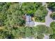 Aerial view of a home surrounded by lush trees, showcasing the property's privacy at 103 Lochwood West Dr, Cary, NC 27518
