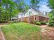 Lush backyard with green grass and mature plantings offering a private outdoor space at 103 Lochwood West Dr, Cary, NC 27518