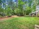 Well-manicured backyard with mature trees, offering a tranquil outdoor setting at 103 Lochwood West Dr, Cary, NC 27518