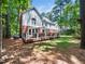 Beautiful backyard with mature trees, and a large deck, providing a serene outdoor retreat at 103 Lochwood West Dr, Cary, NC 27518