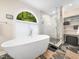 Bathroom with a modern free-standing tub, walk-in shower, and a decorative window at 103 Lochwood West Dr, Cary, NC 27518